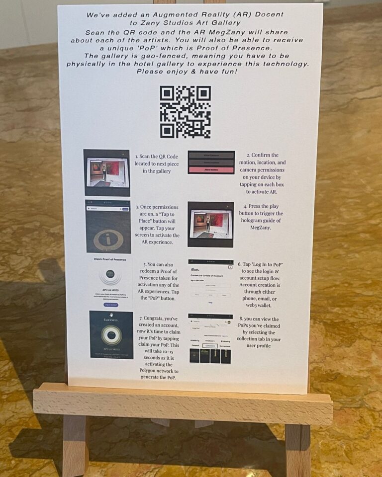 A printed sign on an easel with a QR code and step-by-step instructions for the AR docent at Zany Studios Art Gallery