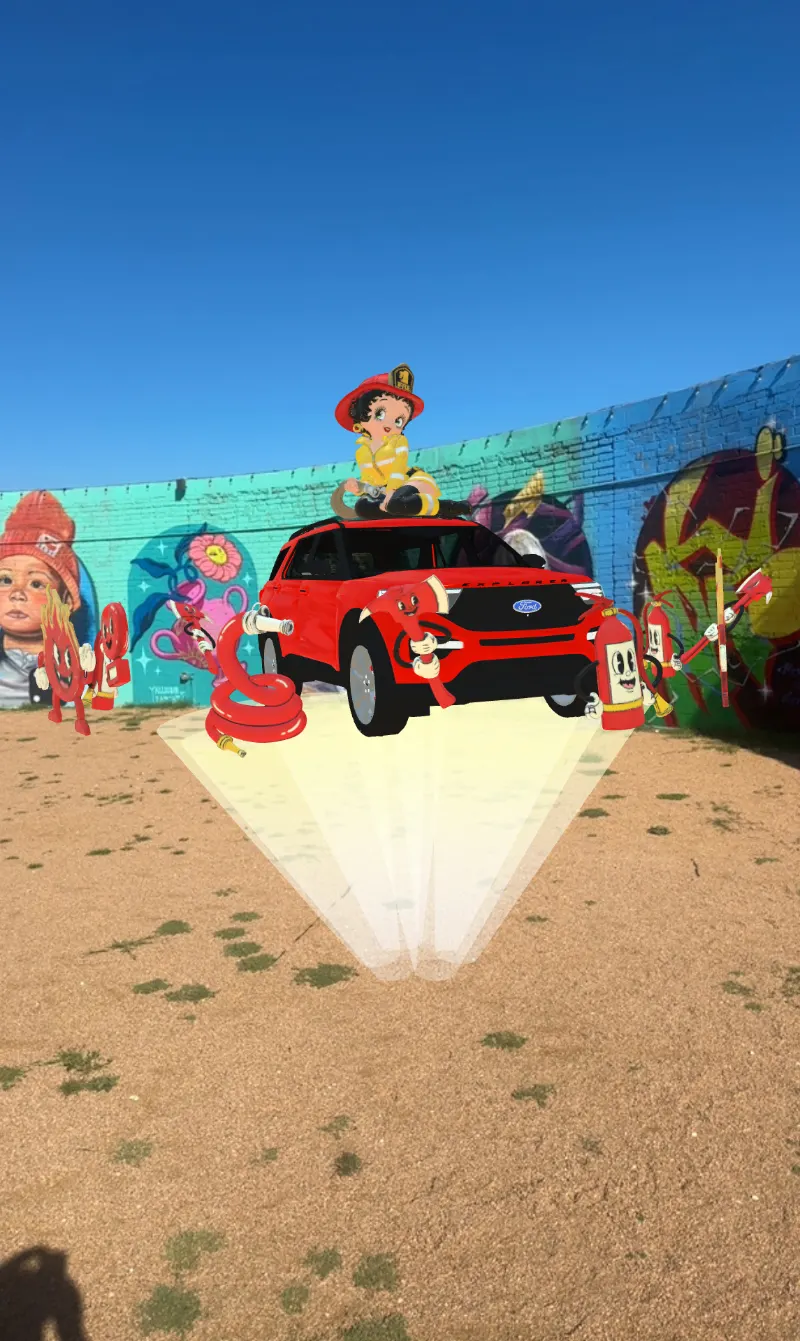 Phone view of an AR character riding a red car in front of a desert mural